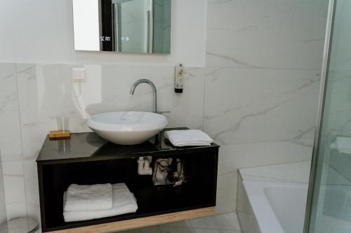 a white bathroom with a sink and a shower at Lamede SELF CHECK-IN in Wiener Neustadt