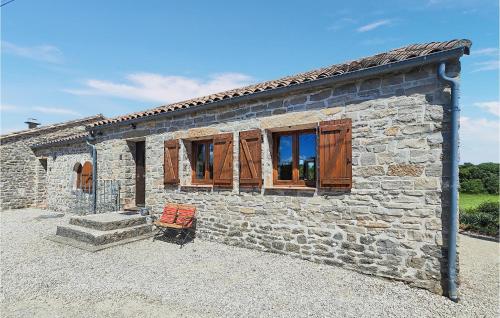 a stone house with wooden windows and a bench at Lovely Home In Saint-Félix-De-L'héras in Saint-Félix-de-lʼHéras