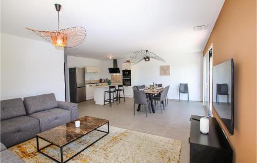 a living room with a couch and a table at Lovely Home In Cléon D'andran in Cléon-dʼAndran