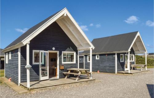 a blue house with a picnic table in front of it at Hytte 1 in Thyborøn