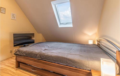 a bedroom with a bed and a window at 2 Bedroom Gorgeous Home In Hennstedt in Hennstedt