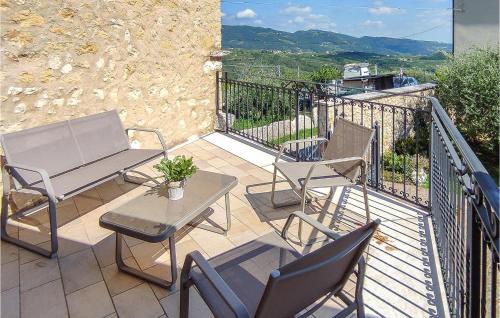 a patio with a table and chairs on a balcony at Nice Home In Marano Di Valpolicella in Marano di Valpolicella