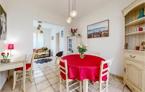 une cuisine et une salle à manger avec une table et des chaises rouges dans l'établissement 2 Bedroom Gorgeous Home In Royan, à Royan