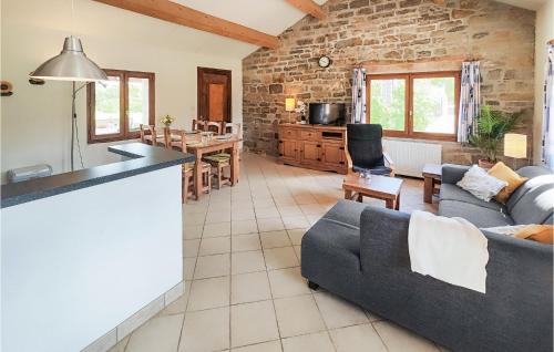 a kitchen and living room with a couch and a table at Lovely Home In Saint-Félix-De-L'héras in Saint-Félix-de-lʼHéras