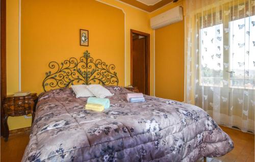 a bedroom with a large bed with yellow walls at Gorgeous Home In Fivizzano With Wifi in Fivizzano