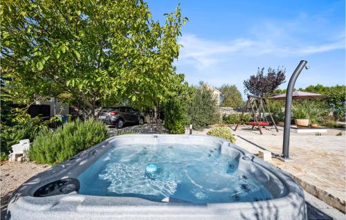 a hot tub in a yard with a playground at Stunning Home In Jadrija in Jadrija