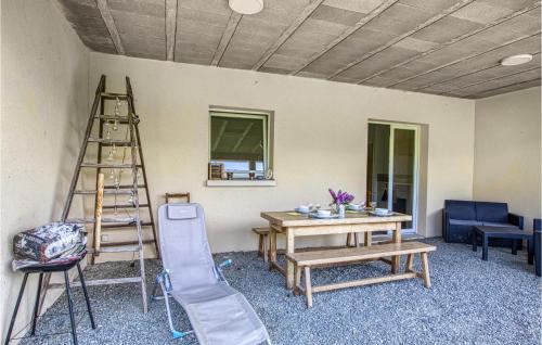 a living room with a ladder and a table and a ladder at Lovely Apartment In Conques-En-Rouergue in Conques-en-Rouergue