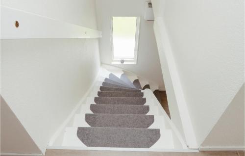 a staircase in a house with a grey carpet at Gorgeous Home In Lammhult in Lammhult