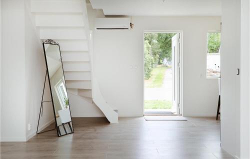 a hallway with a mirror and a stair case at Gorgeous Home In Lammhult in Lammhult