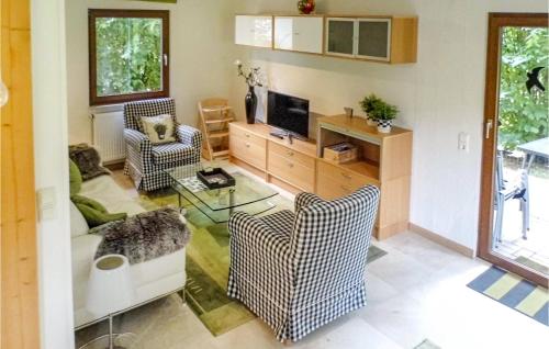 a living room with two chairs and a television at 3 Bedroom Beautiful Home In Kirchheim in Kirchheim