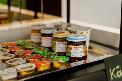 a bunch of jars of food on a counter at Nava Motel SELF CHECK-IN in Wiener Neustadt