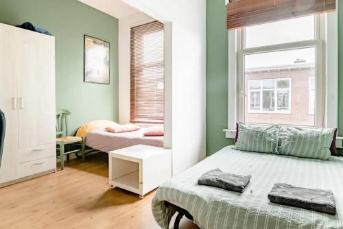 a bedroom with two beds and a mirror at Cozy private room in shared apartment, close to beach and city center in The Hague