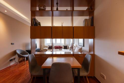 a dining room with a table and chairs at Central Park Apartments in Belgrade