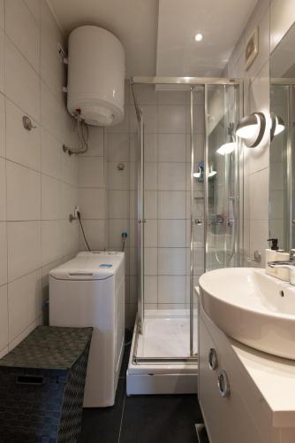 a bathroom with a shower and a toilet and a sink at Central Park Apartments in Belgrade