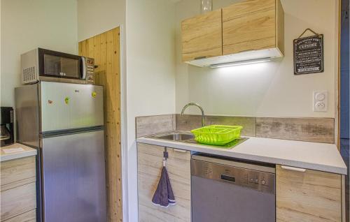 a kitchen with a stainless steel refrigerator and a sink at Lovely Apartment In Conques-En-Rouergue in Conques-en-Rouergue