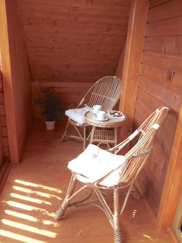 two chairs and a table on a porch at Chalet Tatry in Horná Lehota