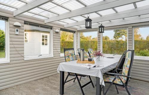 a dining room with a table and chairs on a patio at Pet Friendly Home In Odder With Wifi in Odder