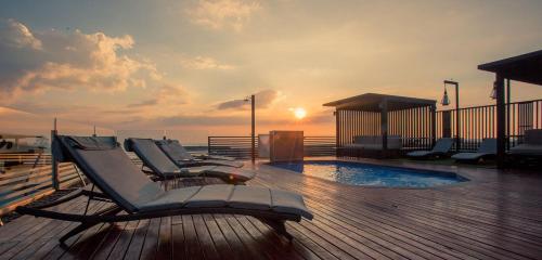 a deck with lounge chairs and a pool on a boat at Inn Residence Serviced Suites - SHA Extra Plus in Jomtien Beach
