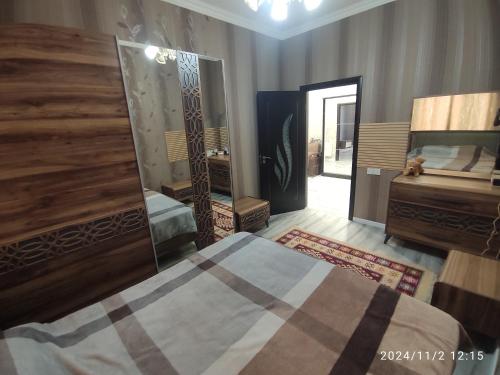 a bedroom with a bed and a large mirror at 3 комнат Центр Города всё рядом in Xirdalan