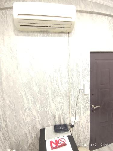 a bathroom with a air conditioner on a wall at 3 комнат Центр Города всё рядом in Xirdalan