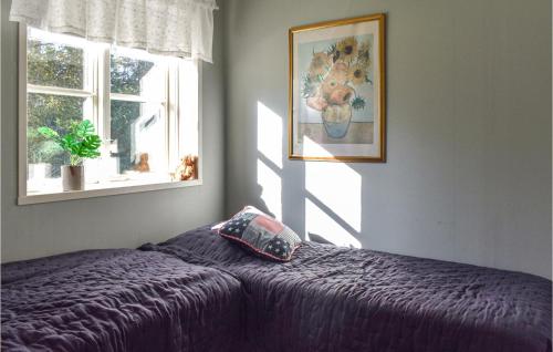 a bedroom with a purple bed with a pillow on it at Lovely Home In Simrishamn With Kitchen in Simrishamn