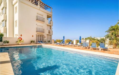 a swimming pool in front of a building at 2 Bedroom Lovely Apartment In Marbella in Marbella