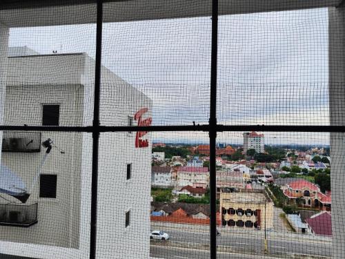 a view of a city from a window at Honrosa Studio at KBCC Service Apartment -with unifi in Kota Bharu