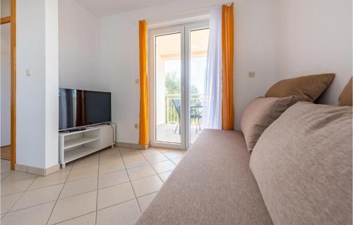 a living room with a couch and a television at Vila Sidro in Košljun