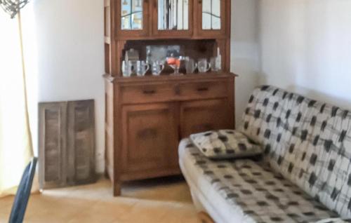 a living room with a cabinet and a couch at 4 Bedroom Lovely Home In Rybical in Ryn