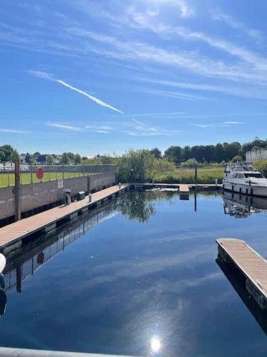 a boat is docked at a dock in the water at Centrally Located Carrick on Shannon Shore Side Apartment in Carrick on Shannon