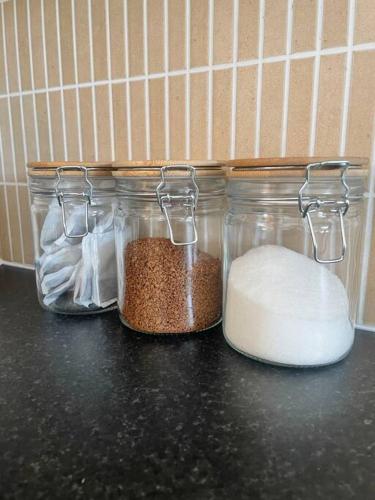 three glass jars sitting on top of a counter at Centrally Located Carrick on Shannon Shore Side Apartment in Carrick on Shannon