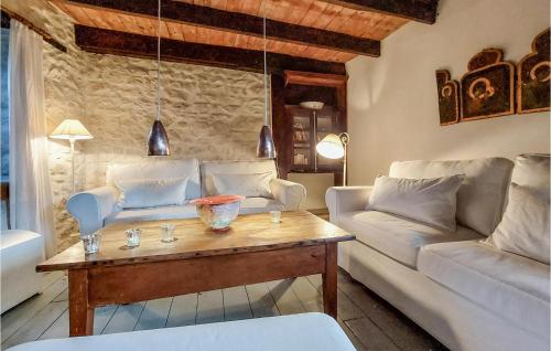 a living room with a couch and a table at 2 Bedroom Amazing Home In Olliergues in Olliergues
