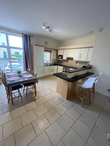 a kitchen with a table and chairs and a dining room at Centrally Located Carrick on Shannon Shore Side Apartment in Carrick on Shannon