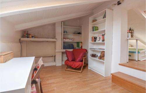 a living room with a red chair and shelves at Amazing Apartment In Marzabotto in Marzabotto