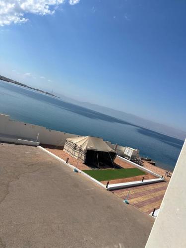 a large tent on the side of a body of water at فندق حياة حقل الفندقية Hayat Haql Hotel in Al Humaizah