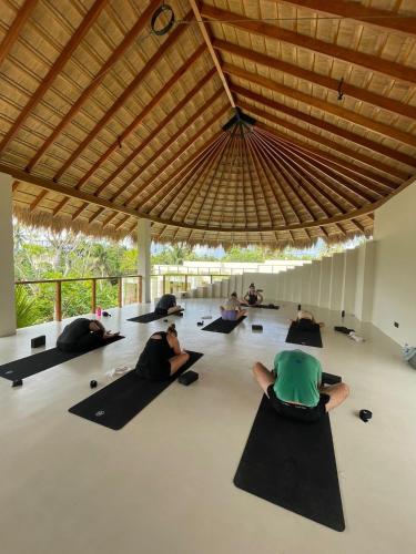 a group of people doing yoga in a building at Meraki in Polhena