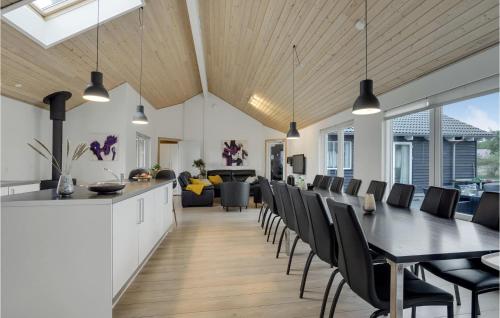 a dining room and living room with a table and chairs at Amazing Home In Sydals With Sauna in Høruphav