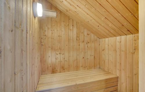 a wooden sauna with a light on the ceiling at Holiday Home Tjørnevænget Humble Ix in Humble