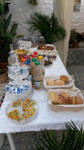 a table with many plates of food on it at B&B Gi & Giò in Càbras
