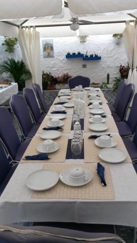 a long table with plates and dishes on it at B&B Gi & Giò in Càbras