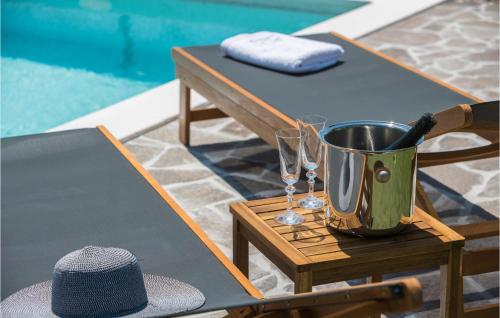 a table with wine glasses and a bucket on a table at Gorgeous Home In Roc With Wifi in Roč