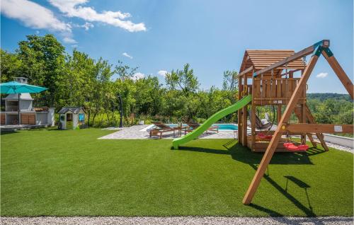 a playground with a slide and a swing at Gorgeous Home In Roc With Wifi in Roč