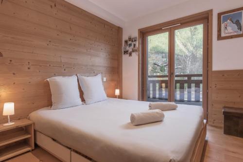 une chambre avec un grand lit et une fenêtre dans l'établissement Grand Paradis, à Chamonix-Mont-Blanc