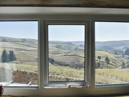 a window with a view of a field at Writers Cottage - Uk33475 in Nenthead