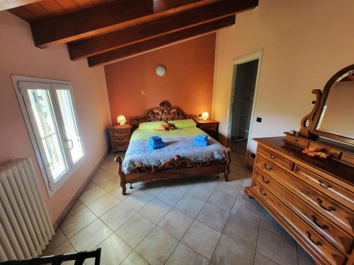 a bedroom with a bed and a dresser and a mirror at Podere Elisa in Vezzano sul Crostolo