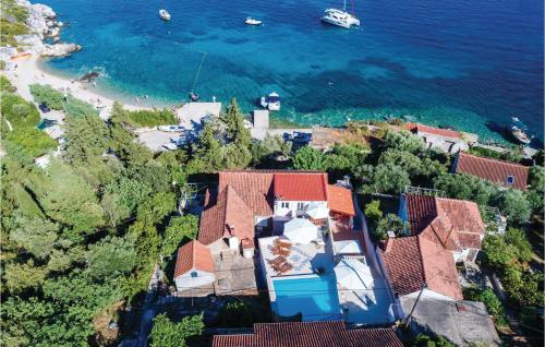 an aerial view of a house next to the ocean at Six-Bedroom Holiday Home In Sipan in Suđurađ