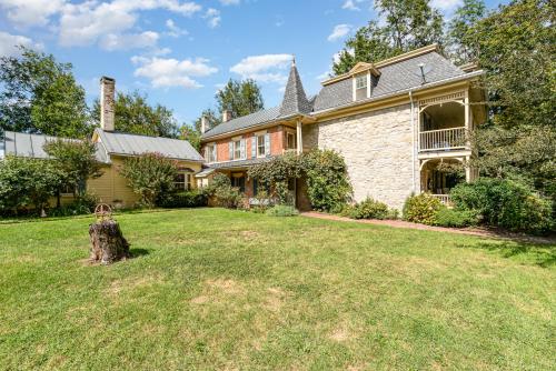 a house with a yard with a tree stump at Fallen Tree Farm Bed and Breakfast in Carlisle