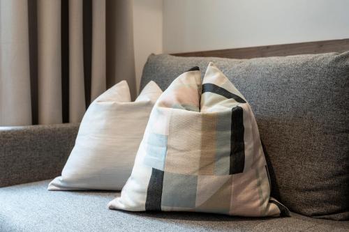 two pillows are sitting on a couch at Hotel Gasthof Brüggler in Radstadt