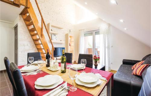a dining room with a table with wine glasses at Two-Bedroom Apartment In Ogulin in Jasenak