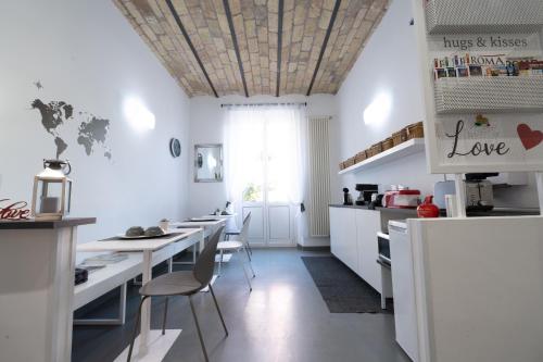 a kitchen with a table and chairs and a refrigerator at Inn Urbe Colosseo in Rome